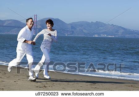 USA, California, San Francisco, Elder couple jogging on beach View Large Photo Image Stock Image - USA, California, San Francisco, Elder couple jogging on beach. Fotosearch