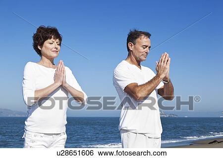 USA, California, San Francisco, Elder couple practicing yoga on beach View Large Photo Image Stock Photograph - USA, California, San Francisco, Elder couple practicing yoga on beach. Fotosearch