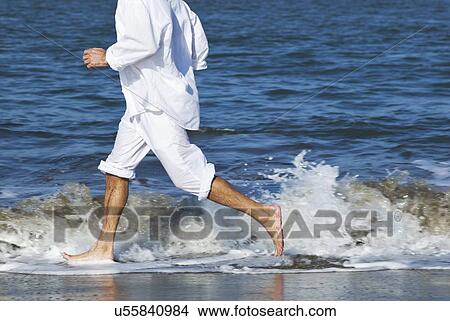 USA, California, San Francisco, Man jogging on beach View Large Photo Image Picture - USA, California, San Francisco, Man jogging on beach. Fotosearch