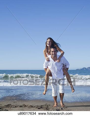 USA, California, San Francisco, man giving woman piggy back on Baker Beach View Large Photo Image Picture - USA, California, San Francisco, man giving woman piggy back on Baker Beach. Fotosearch