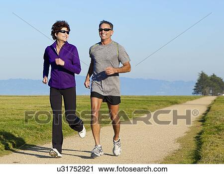 USA, California, San Francisco, Mature couple jogging in countryside View Large Photo Image Stock Image - USA, California, San Francisco, Mature couple jogging in countryside. Fotosearch