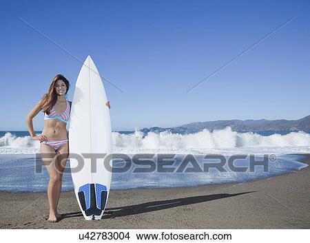 USA, California, San Francisco, portrait of young woman holding surfboard on Baker Beach View Large Photo Image Picture - USA, California, San Francisco, portrait of young woman holding surfboard on Baker Beach. Fotosearch