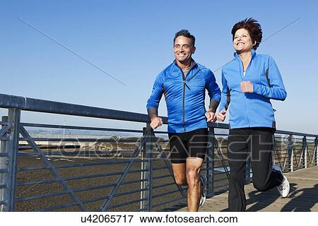USA, California, San Francisco, Senior couple jogging on boardwalk View Large Photo Image Stock Photo - USA, California, San Francisco, Senior couple jogging on boardwalk. Fotosearch
