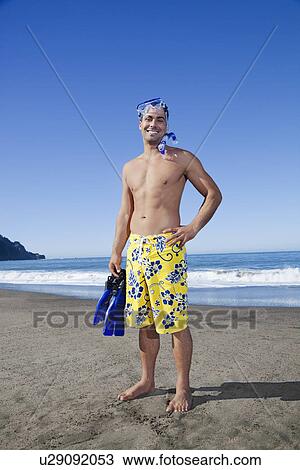 Stock Image - USA, California, San Francisco, portrait of man with snorkel gear on Baker Beach. Fotosearch