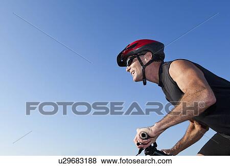 USA, California, San Francisco, Portrait of cyclist in helmet against blue sky View Large Photo Image Stock Photo - USA, California, San Francisco, Portrait of cyclist in helmet against blue sky. Fotosearch