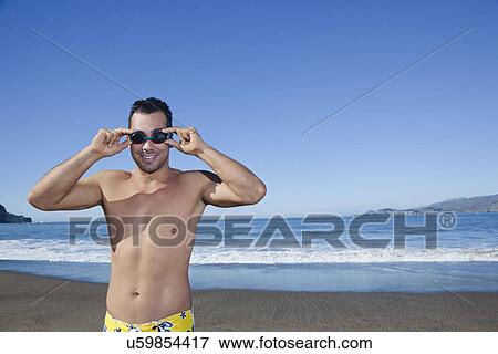 USA, California, San Francisco, portrait of man adjusting goggles on Baker Beach View Large Photo Image Stock Photo - USA, California, San Francisco, portrait of man adjusting goggles on Baker Beach. Fotosearch