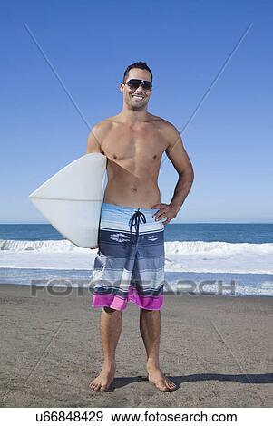 USA, California, San Francisco, portrait of man holding surfboard on Baker Beach View Large Photo Image Stock Photo - USA, California, San Francisco, portrait of man holding surfboard on Baker Beach. Fotosearch