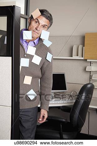Picture - USA, California, San Rafael, business man with adhesive notes taped on him. Fotosearch