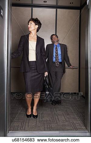 USA, California, San Rafael, business woman and business man in elevator View Large Photo Image Stock Image - USA, California, San Rafael, business woman and business man in elevator. Fotosearch