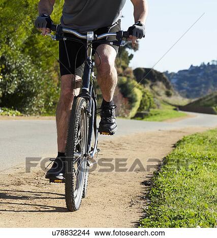 Picture - USA, California, Tiburon, Cyclist on country road. Fotosearch