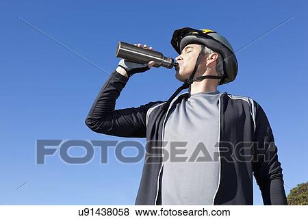 USA, California, Tiburon, Cyclist drinking water View Large Photo Image Stock Photo - USA, California, Tiburon, Cyclist drinking water. Fotosearch