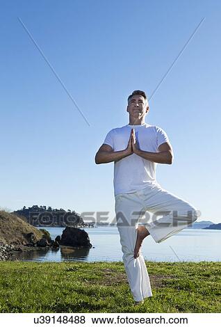 USA, California, Tiburon, Man practicing yoga on lakeside View Large Photo Image Stock Photo - USA, California, Tiburon, Man practicing yoga on lakeside. Fotosearch