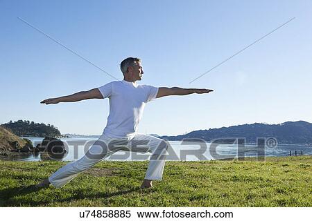 USA, California, Tiburon, Man practicing yoga on lakeside View Large Photo Image Stock Photography - USA, California, Tiburon, Man practicing yoga on lakeside. Fotosearch