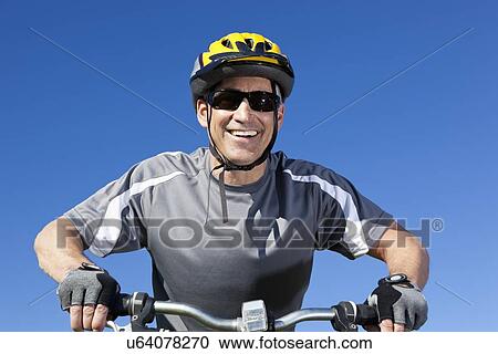 USA, California, Tiburon, Portrait of cyclist against blue sky View Large Photo Image Stock Image - USA, California, Tiburon, Portrait of cyclist against blue sky. Fotosearch
