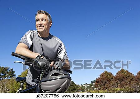 USA, California, Tiburon, Portrait of cyclist against blue sky View Large Photo Image Stock Photograph - USA, California, Tiburon, Portrait of cyclist against blue sky. Fotosearch