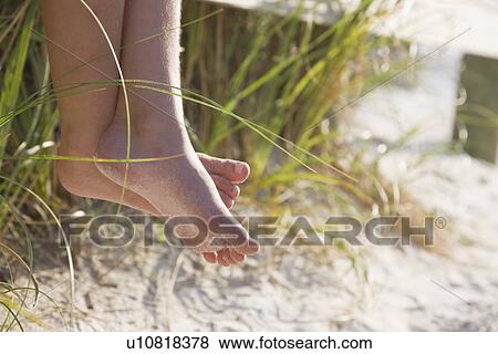 USA, Florida, St. Pete Beach, Bare feet of girl (8-9) sitting on rail on beach View Large Photo Image Stock Photo - USA, Florida, St. Pete Beach, Bare feet of girl (8-9) sitting on rail on beach. Fotosearch