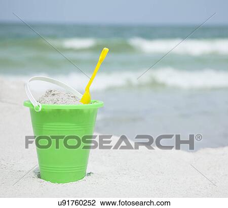 Stock Image - USA, Florida, St. Pete Beach, Bucket and shovel on beach. Fotosearch