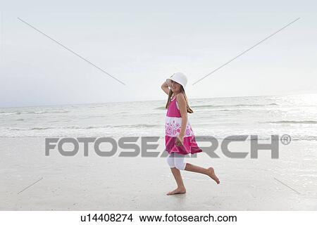 USA, Florida, St. Pete Beach, Girl (8-9) walking on beach View Large Photo Image Picture - USA, Florida, St. Pete Beach, Girl (8-9) walking on beach. Fotosearch