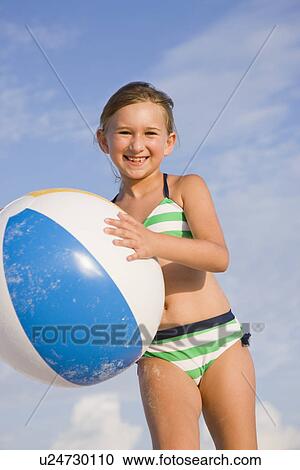 USA, Florida, St. Pete Beach, girl (8-9) with ball on beach View Large Photo Image Stock Image - USA, Florida, St. Pete Beach, girl (8-9) with ball on beach. Fotosearch
