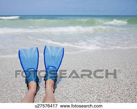 Stock Photo - USA, Florida, St. Pete Beach, Girl's feet (8-9) with flippers on beach. Fotosearch