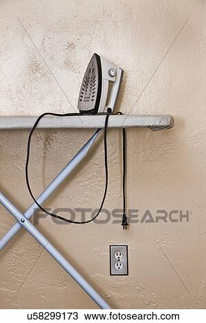 USA, Florida, St. Pete Beach, Iron on ironing board against wall View Large Photo Image Stock Image - USA, Florida, St. Pete Beach, Iron on ironing board against wall. Fotosearch