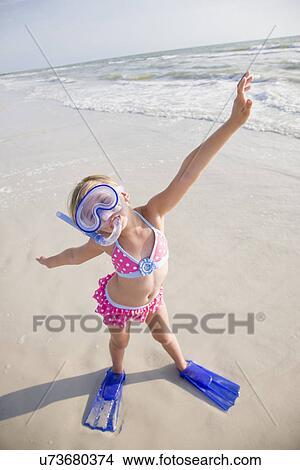 Picture - USA, Florida, St. Pete Beach, Portrait of girl (8-9) in diving equipment on beach. Fotosearch