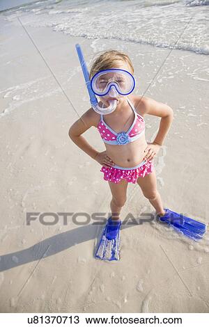 Stock Image - USA, Florida, St. Pete Beach, Portrait of girl (8-9) in diving equipment on beach. Fotosearch