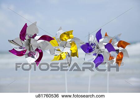 Stock Photograph - USA, Florida, St. Pete Beach, Row of pinwheels on beach. Fotosearch