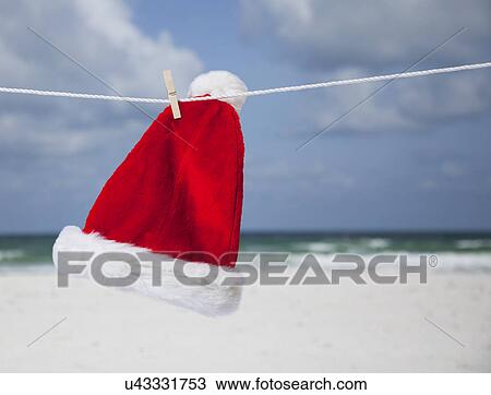 USA, Florida, St. Pete Beach, Santa hat hanging on clothesline on beach View Large Photo Image Stock Image - USA, Florida, St. Pete Beach, Santa hat hanging on clothesline on beach. Fotosearch