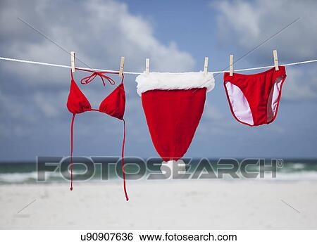 USA, Florida, St. Pete Beach, Santa hat and bikini hanging on clothesline on beach View Large Photo Image Stock Photograph - USA, Florida, St. Pete Beach, Santa hat and bikini hanging on clothesline on beach. Fotosearch