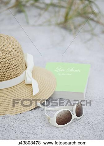 USA, Florida, St. Pete Beach, Straw hat, sunglasses and book on beach View Large Photo Image Stock Photo - USA, Florida, St. Pete Beach, Straw hat, sunglasses and book on beach. Fotosearch