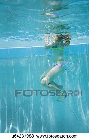 Stock Photo - USA Florida, St. Pete Beach, Underwater shot of girl (8-9) swimming. Fotosearch