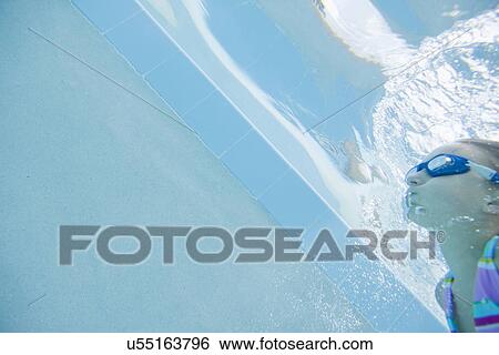 Stock Photograph - USA Florida, St. Pete Beach, Underwater shot of girl (8-9) diving. Fotosearch