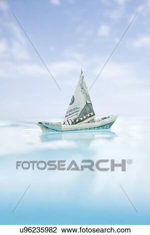 Stock Image - USA, Florida, St. Petersburg, Boat made of fifty dollar banknote floating on water. Fotosearch