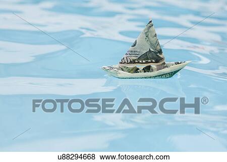 USA, Florida, St. Petersburg, Boat made of fifty dollar banknote floating on water View Large Photo Image Stock Photo - USA, Florida, St. Petersburg, Boat made of fifty dollar banknote floating on water. Fotosearch