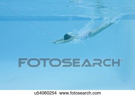 Picture - USA, Florida, St. Petersburg, Girl (10-11) diving in swimming pool. Fotosearch