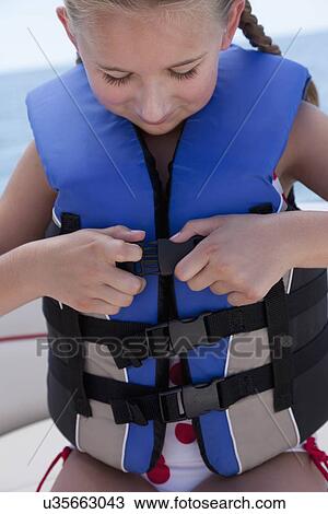 USA, Florida, St. Petersburg, Girl (10-11) fastening life jacket in speedboat View Large Photo Image Stock Image - USA, Florida, St. Petersburg, Girl (10-11) fastening life jacket in speedboat. Fotosearch