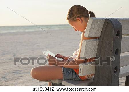 USA, Florida, St. Petersburg, Girl (10-11) using digital tablet on beach at sunset View Large Photo Image Stock Image - USA, Florida, St. Petersburg, Girl (10-11) using digital tablet on beach at sunset. Fotosearch