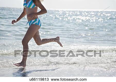 USA, Florida, St. Petersburg, girl (12-13) running along beach View Large Photo Image Stock Image - USA, Florida, St. Petersburg, girl (12-13) running along beach. Fotosearch