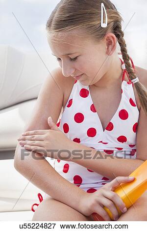 USA, Florida, St. Petersburg, Girl (10-11) applying sun lotion on arm View Large Photo Image Stock Photo - USA, Florida, St. Petersburg, Girl (10-11) applying sun lotion on arm. Fotosearch