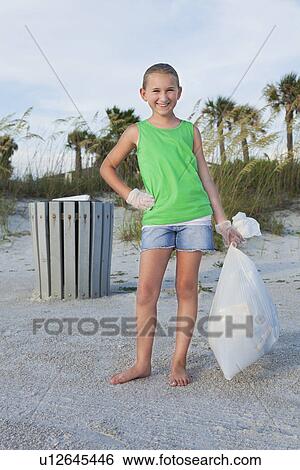 USA, Florida, St. Petersburg, Girl (10-11) holding garbage bag on beach View Large Photo Image Stock Photograph - USA, Florida, St. Petersburg, Girl (10-11) holding garbage bag on beach. Fotosearch