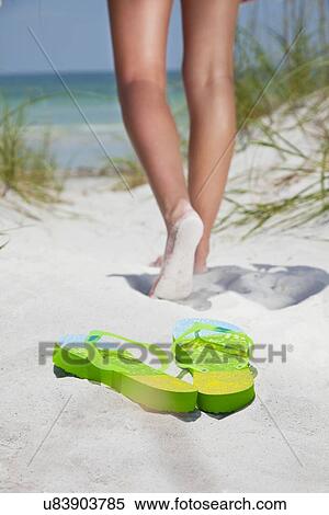 USA, Florida, St. Petersburg, Pair of flip flops on sandy beach and girl (12-13) in background View Large Photo Image Stock Photography - USA, Florida, St. Petersburg, Pair of flip flops on sandy beach and girl (12-13) in background. Fotosearch