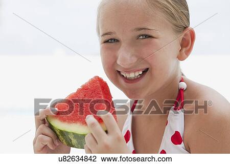 USA, Florida, St. Petersburg, Portrait of smiling girl (10-11) holding slice of watermelon View Large Photo Image Stock Image - USA, Florida, St. Petersburg, Portrait of smiling girl (10-11) holding slice of watermelon. Fotosearch