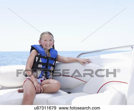 USA, Florida, St. Petersburg, Portrait of smilling girl (10-11) wearing life jacket in speedboat View Large Photo Image Stock Photo - USA, Florida, St. Petersburg, Portrait of smilling girl (10-11) wearing life jacket in speedboat. Fotosearch