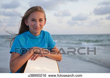 USA, Florida, St. Petersburg, portrait of girl (12-13) leaning on boogie board View Large Photo Image Stock Photograph - USA, Florida, St. Petersburg, portrait of girl (12-13) leaning on boogie board. Fotosearch