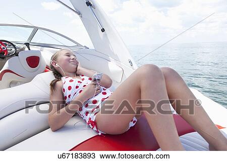 USA, Florida, St. Petersburg, Smilling girl (10-11) listening music on yacht View Large Photo Image Stock Image - USA, Florida, St. Petersburg, Smilling girl (10-11) listening music on yacht. Fotosearch