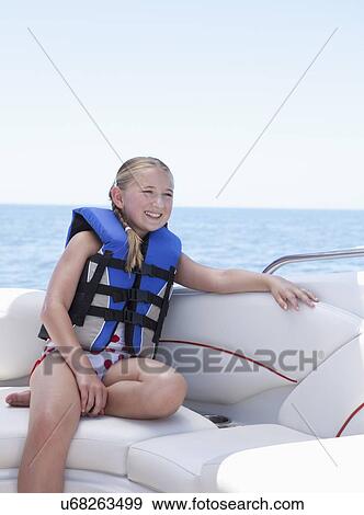 USA, Florida, St. Petersburg, Smilling girl (10-11) wearing life jacket in speedboat View Large Photo Image Stock Photo - USA, Florida, St. Petersburg, Smilling girl (10-11) wearing life jacket in speedboat. Fotosearch