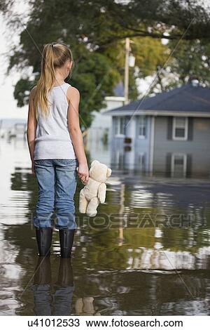 USA, Illinois, Chillicothe, Girl (8-9) holding teddy bear and standing in water, rear view View Large Photo Image Stock Image - USA, Illinois, Chillicothe, Girl (8-9) holding teddy bear and standing in water, rear view. Fotosearch