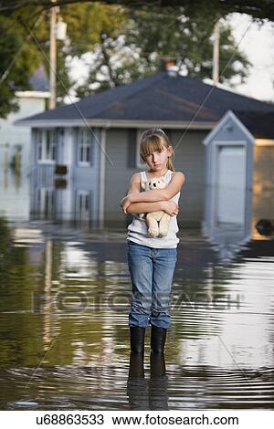 USA, Illinois, Chillicothe, Girl (8-9) carrying teddy bear and standing in water View Large Photo Image Stock Image - USA, Illinois, Chillicothe, Girl (8-9) carrying teddy bear and standing in water. Fotosearch