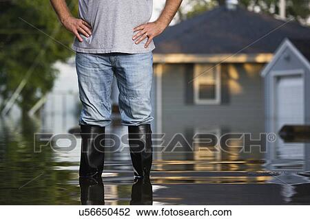 USA, Illinois, Chillicothe, Mid adult man standing in water in rubber boots, Mid section View Large Photo Image Stock Image - USA, Illinois, Chillicothe, Mid adult man standing in water in rubber boots, Mid section. Fotosearch